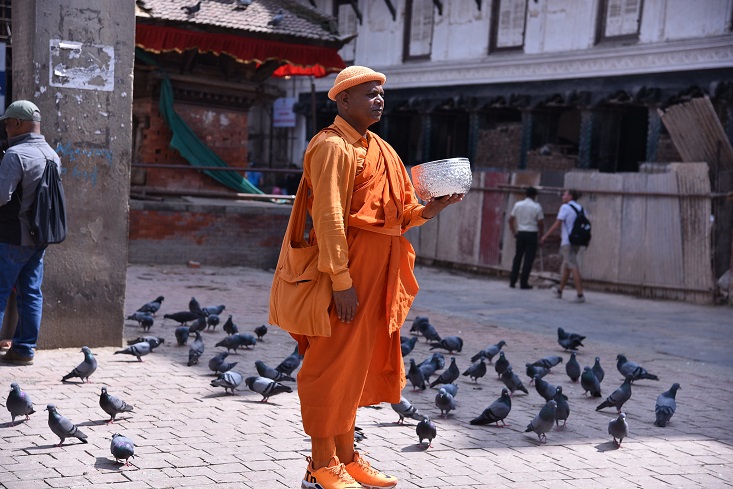 dana Monk doing Tak Baht or merit making or beggar_Nepal_by Shankar S via Flickr